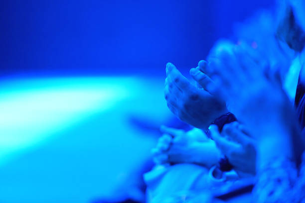 Human hands silhouette behind frosted glass