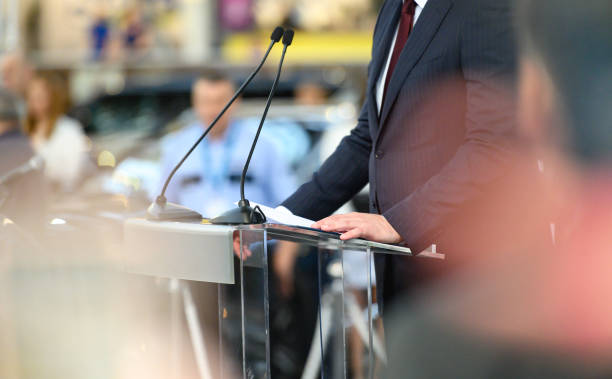 Political public speech during a political rally Unrecognizable business person or politician is giving a speech during political rally, reading something from piece of paper, Nikon Z7 spokesperson stock pictures, royalty-free photos & images