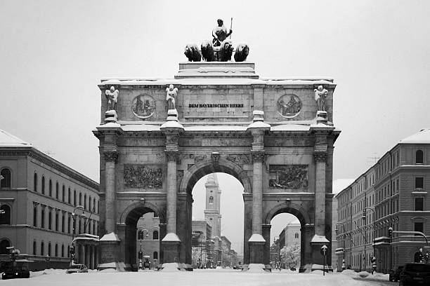 Munich in winter Black & white view of Munich's "Siegestor" covered with snow siegestor stock pictures, royalty-free photos & images
