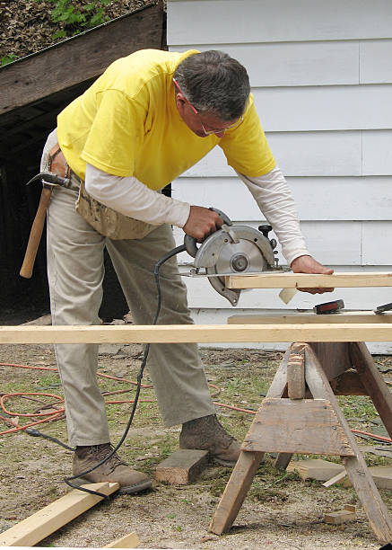 Carpenter using a circular saw stock photo