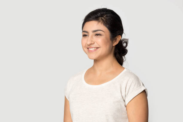 istock Smiling Indian woman look in distance dreaming 1399788015