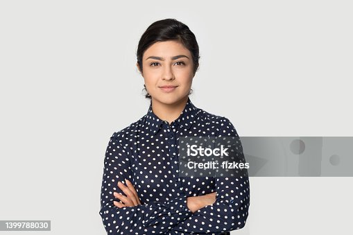 istock Portrait of young confident Indian woman pose on background 1399788030