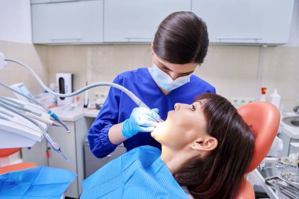 istock Woman patient treating teeth in clinic, treatment process 1399788045
