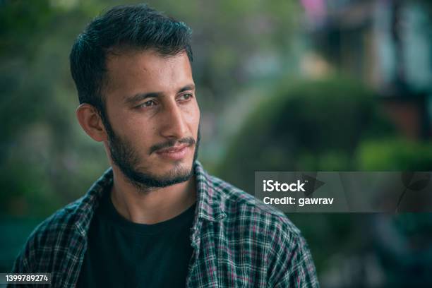 Outdoor Day Portrait Of A Young Man Contemplates And Looks Away Stock Photo - Download Image Now