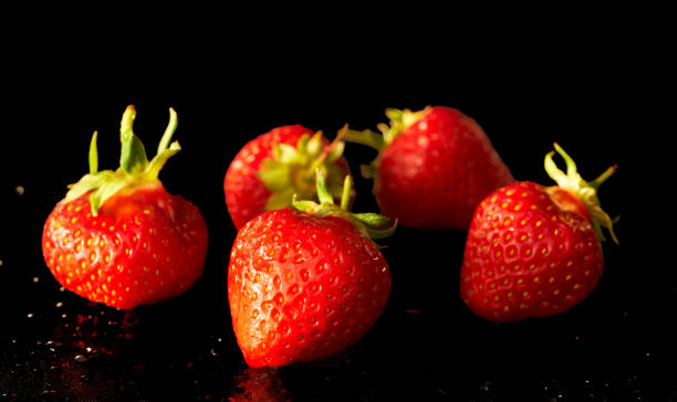 istock strawberry fruits lie on a black background 1399789993