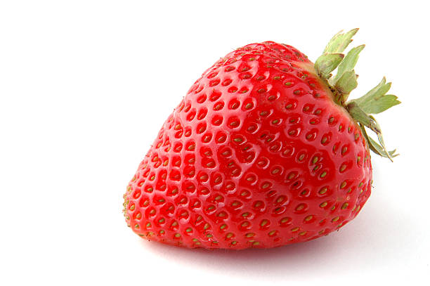 A single red strawberry on a white background stock photo