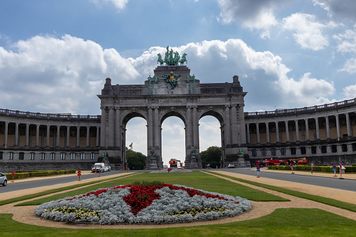 Brussels, Belgium - July 17, 2018: Erected in 1905, this grand monument in a park features a triple arch topped by a bronze sculpture.