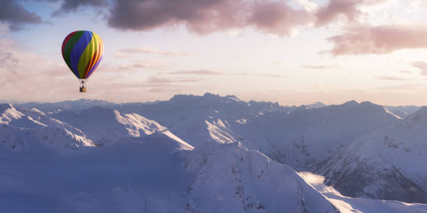 istock Dramatic Mountain Landscape covered in clouds and Hot Air Balloon Flyin 1399797369