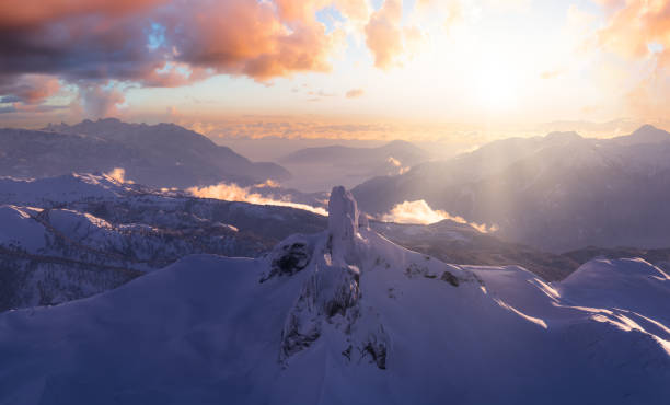 Aerial View from an Airplane of a famous Mountain Peak, Black Tusk. Aerial View from an Airplane of a famous Mountain Peak, Black Tusk. Dramatic Sunset Sky Art Render. Located between Whistler and Squamish, British Columbia, Canada. Winter Nature Background garibaldi park stock pictures, royalty-free photos & images