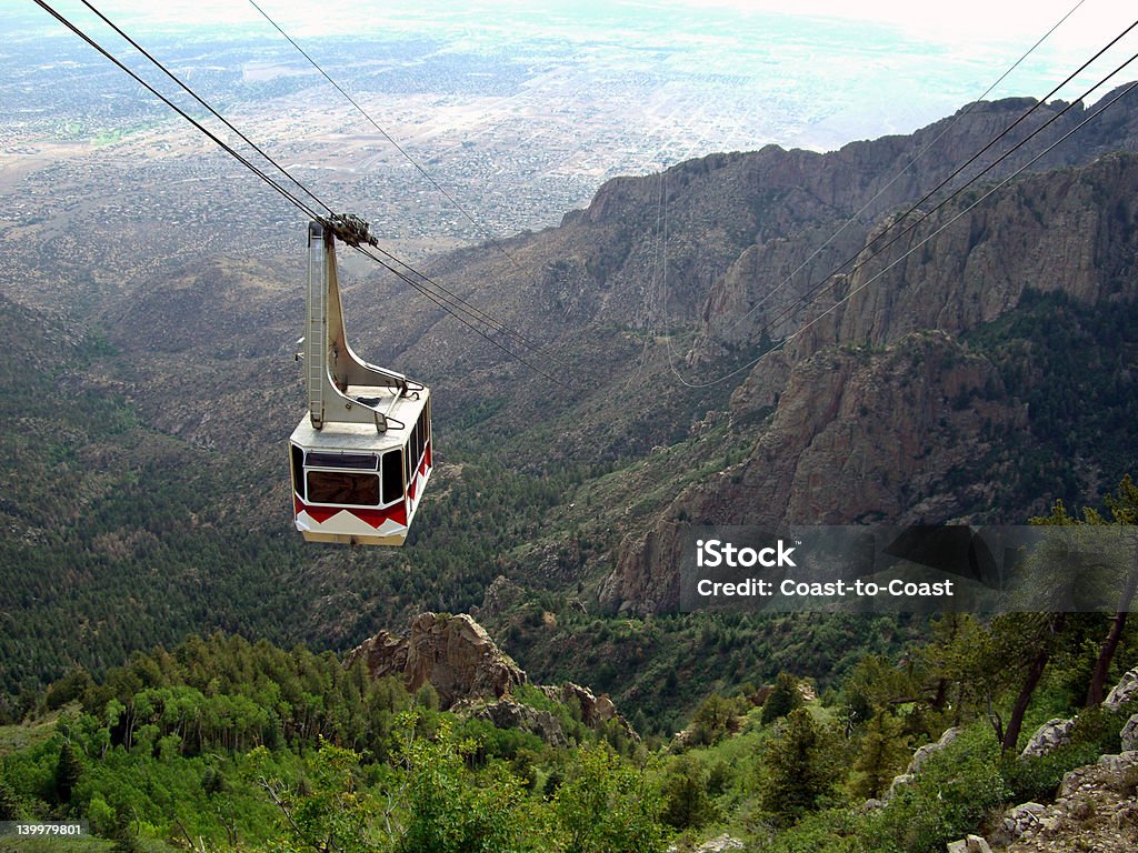 Sandia Tramway Photo of cable car approaching the top of Sandia Mountain in New Mexico.  The city of Albuquerque can be seen in the distance. Albuquerque - New Mexico Stock Photo