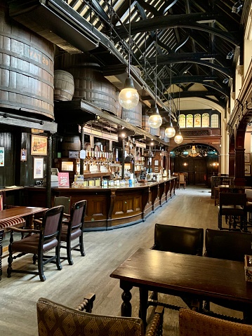 Interior of old charming pub Cittie of Yorke in Holborn, central London at High Holborn street. cozy pub with oak casks high at the ceiling for decoration.