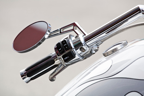 motorcycle - chopper details, handlebar and gas tank closeup, shallow depth of field with focus on switches