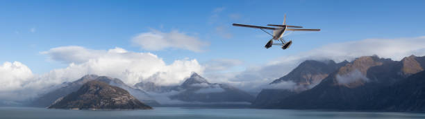 istock Seaplane Aircraft Flying over the Pacific Ocean Coast. 1399801118