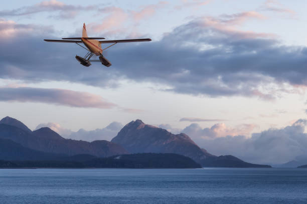 istock Seaplane Aircraft Flying over the Pacific Ocean Coast. 1399801926