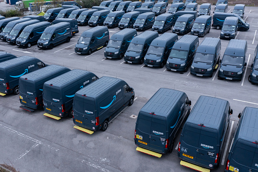 Leeds,  UK - April 26, 2022.  An aerial view of a fleet of Amazon Prime delivery vans for delivering online shopping orders from fulfilment centres to homes