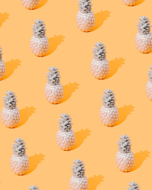 istock Creative summer pattern made of silver colored pineapple on an orange background. Minimal concept. Vertical. 1399802971