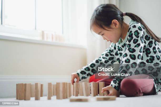Asian Little Girl Paying Domino At Her Room Stock Photo - Download Image Now - Block Removal Game, Domino, Learning