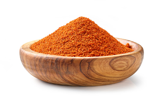 bowl of red pepper powder isolated on white background