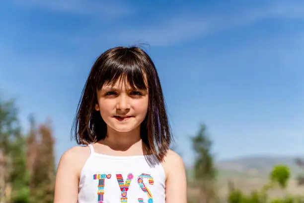 Photo of A portrait of a girl  while looking at the camera