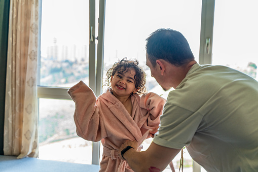 father Drying daughter With Towel After Bath