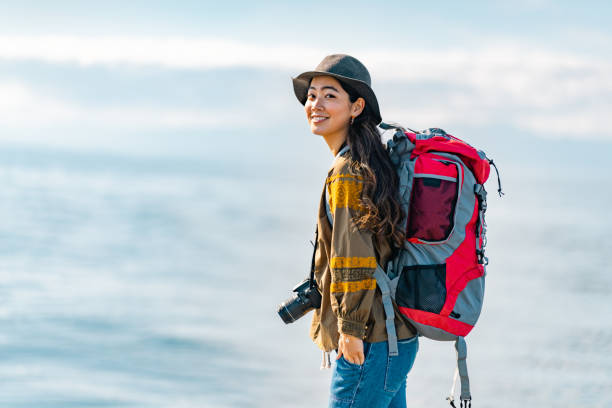istock Young female traveller enjoying spending time at beach on her vacation 1399808192
