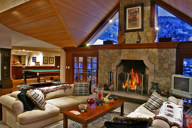 Interior of Luxury Mountain Home Luxurious mountain vacation home.  Interior of winter night with warm fire place inviting living room and great game room aspen colorado photos stock pictures, royalty-free photos & images