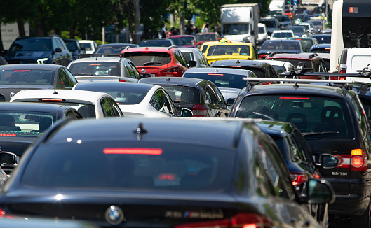 Bucharest, Romania - May 20, 2022: Cars in traffic at rush hour on a boulevard in Bucharest.