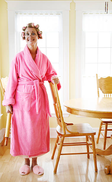 Woman posing in bathroom with rollers in her hair