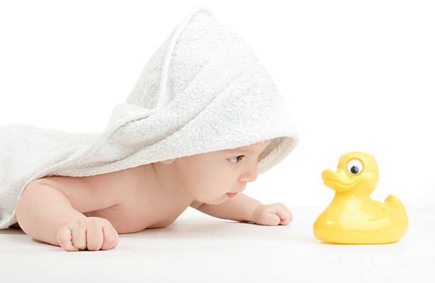 istock Baby in robe after bath time with yellow rubber duck 139981671