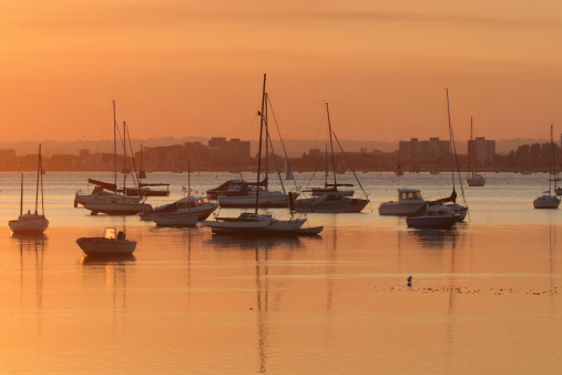 Poole harbour bathed in orange light on a late summer evening
