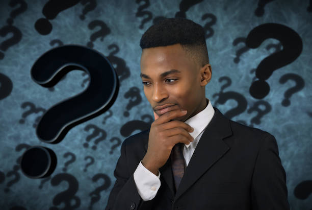 pensive young man thinking doubt expression question mark background - business person suspicion clothing well dressed imagens e fotografias de stock