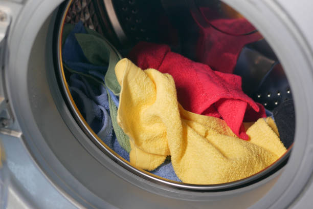 istock close up of cloths in a washing machine. 1399829819