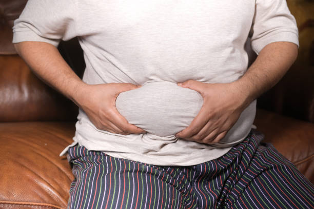istock man's hand holding excessive belly fat, overweight concept 1399830727