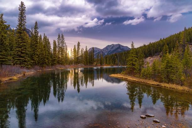 istock Cloudy Sunrise Reflections On Mount Lorette Ponds 1399831489