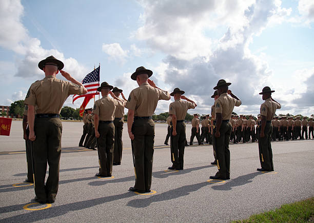 Graduation of Marines from Parris Island 02 Dramatic shot of Drill Instructors saluting the U.S. flag during the graduation of recruits from US Marine Corps Recruit Depot, Parris Island, SC. us marine corps stock pictures, royalty-free photos & images