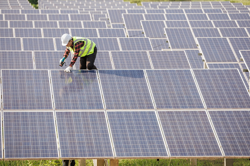 worker installing the solar panels.Solar power energy. renewable energy, technology, electricity, Solar power plant. worker maintenance of solar power plants who perform inspections and maintenance of solar power plants.
