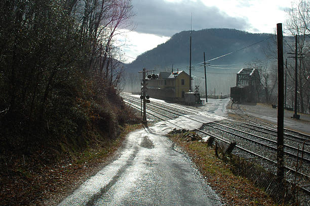 Intersection of roads and RR in small coal mining town in WV during rain