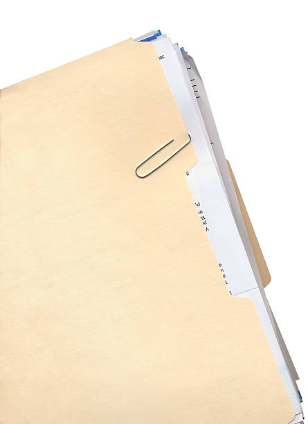 Manila Folder and Paper Clip Manila folder, paper clip, and stack of papers paper clip office supply stack heap stock pictures, royalty-free photos & images