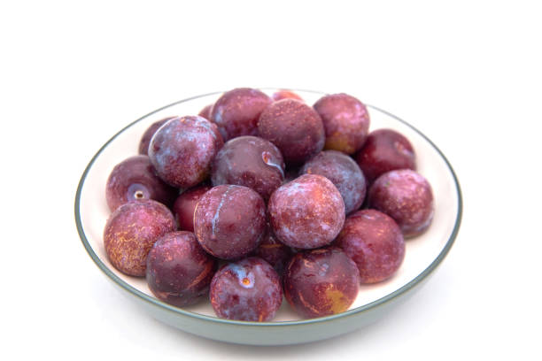 istock Purple plums on white background 1399836707