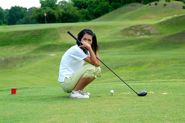Young, female golfer resting stock photo