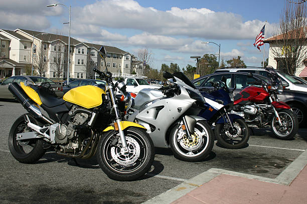 a row of motorbikes parked neatly in a parking lot