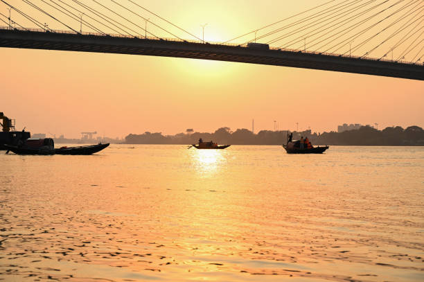 istock Silhouette sunset on river Hooghly with Vidyasagar setu (bridge) at the backdrop. 1399844512