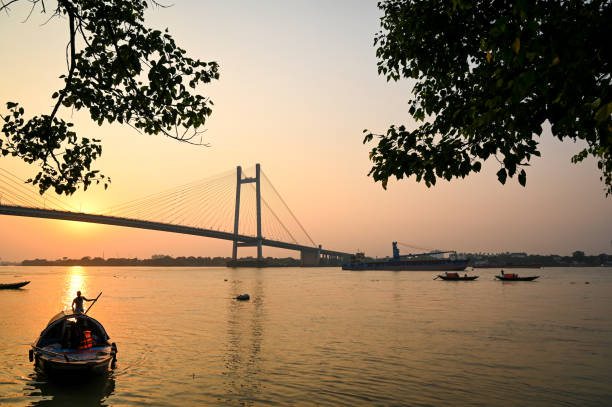 istock Silhouette sunset on river Hooghly with Vidyasagar setu (bridge) at the backdrop. 1399844519