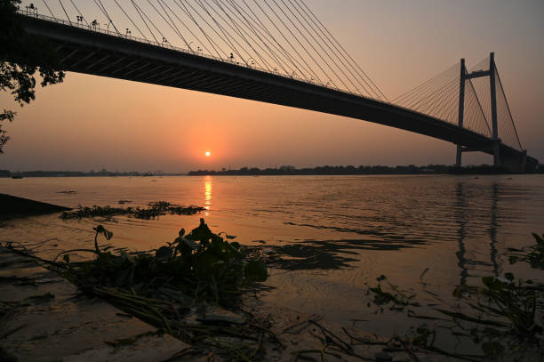 istock Beautiful famous Kolkata Hoogly bridge in sunset . 1399844539
