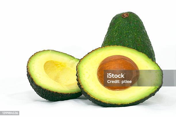Green Whole And Cut Avocado Stock Photo - Download Image Now - Avocado, Brown, Carbohydrate - Biological Molecule