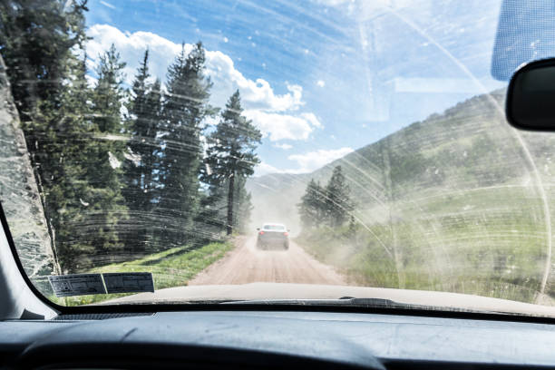driving on a dusty dirt road colorado mountain pass detour - problems adversity conquering adversity roadblock imagens e fotografias de stock
