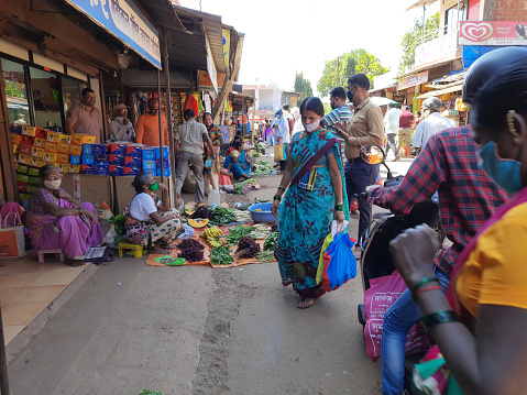 Woman vendor selling vegetables on the market road at village Kasal district Sindhudurg state Maharashtra India