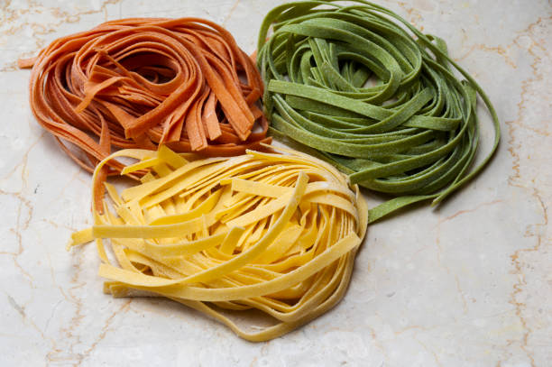 Making pasta Three-color pasta Basic pasta and pasta with spinach and tomatoes. And the food that uses it. spinach pasta stock pictures, royalty-free photos & images