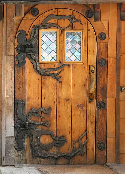 Hand made wooden door with fancy Hobbit hinges.