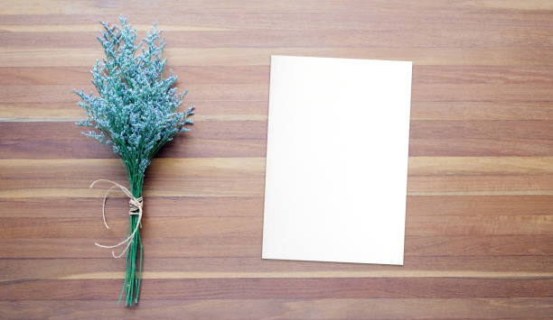 istock Flower bouquet and blank note paper on wood background, banner with copy space, top view, flat lay 1399852580